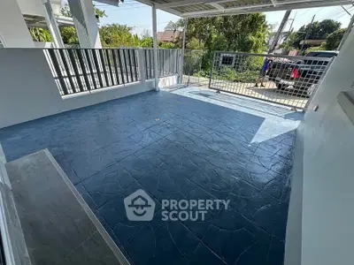 Spacious outdoor balcony with modern railing and textured flooring, perfect for relaxation and entertaining.