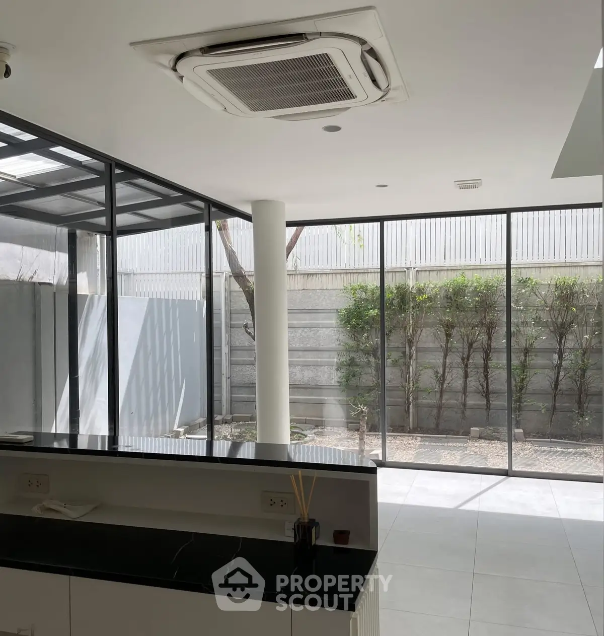 Modern interior with large windows and sleek design, featuring a spacious open layout and abundant natural light.