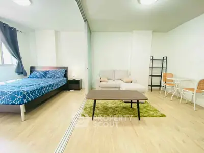 Modern studio apartment with cozy living area and stylish bedroom