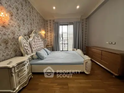 Luxurious bedroom with elegant decor and large window offering natural light.