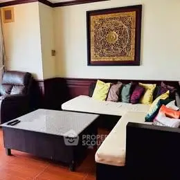 Charming living room with cozy seating and elegant wall art, perfect for relaxation and entertaining.