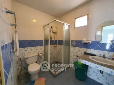 Charming bathroom with shower cabin and floral tile accents