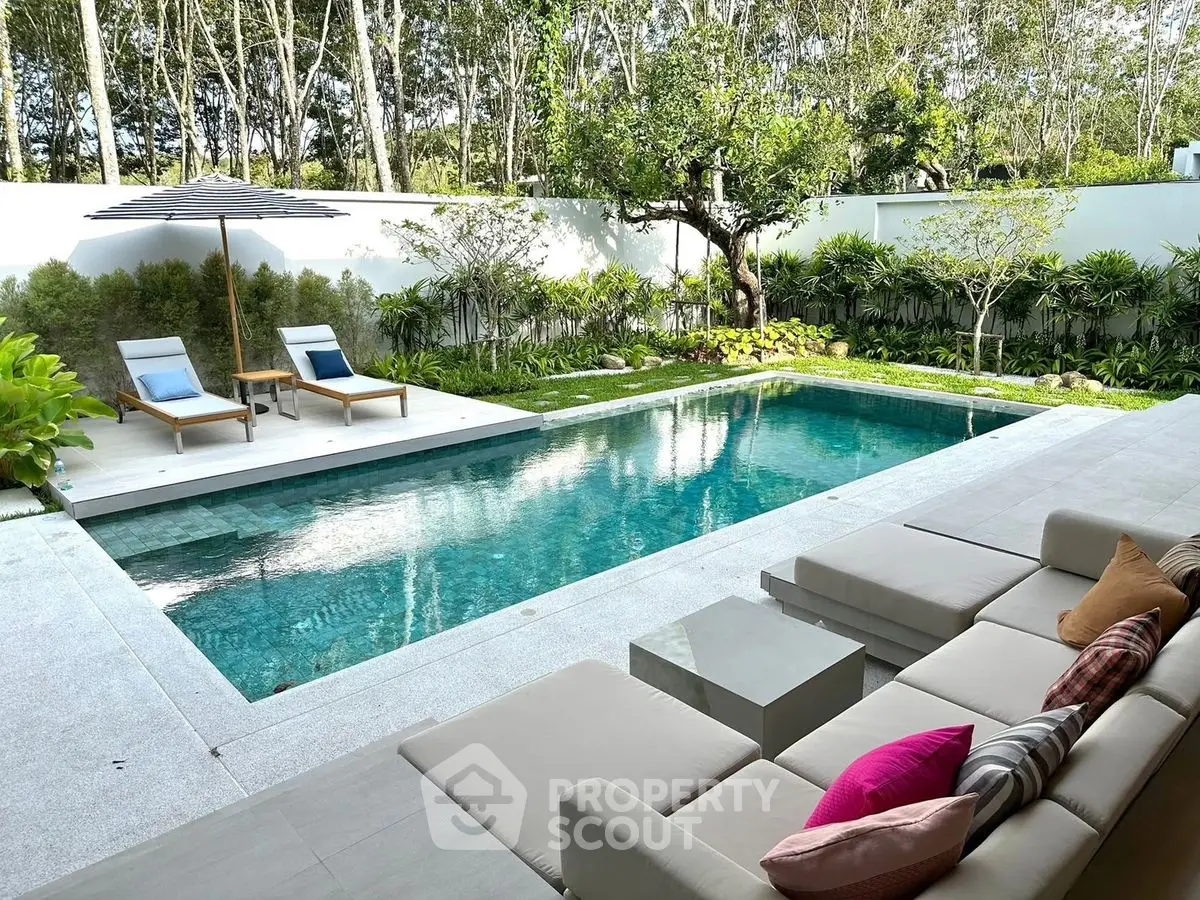 Luxurious backyard with a modern pool and stylish outdoor seating area.