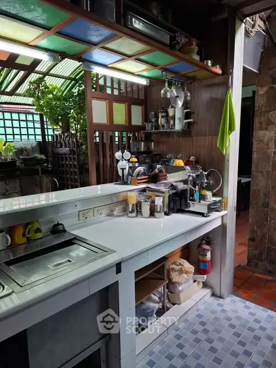 Charming kitchen with colorful ceiling and open layout, featuring modern appliances and cozy atmosphere.