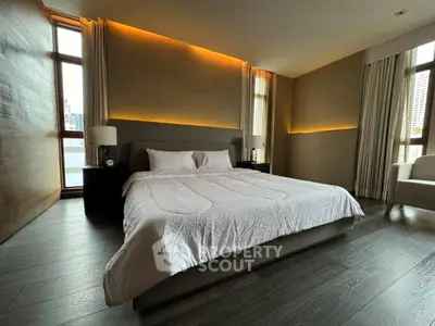 Luxurious bedroom with modern lighting and large windows in upscale apartment