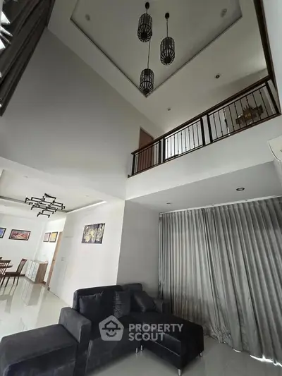 Spacious modern living room with high ceiling and elegant decor