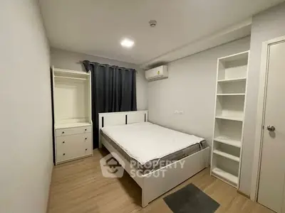 Modern minimalist bedroom with built-in storage and air conditioning