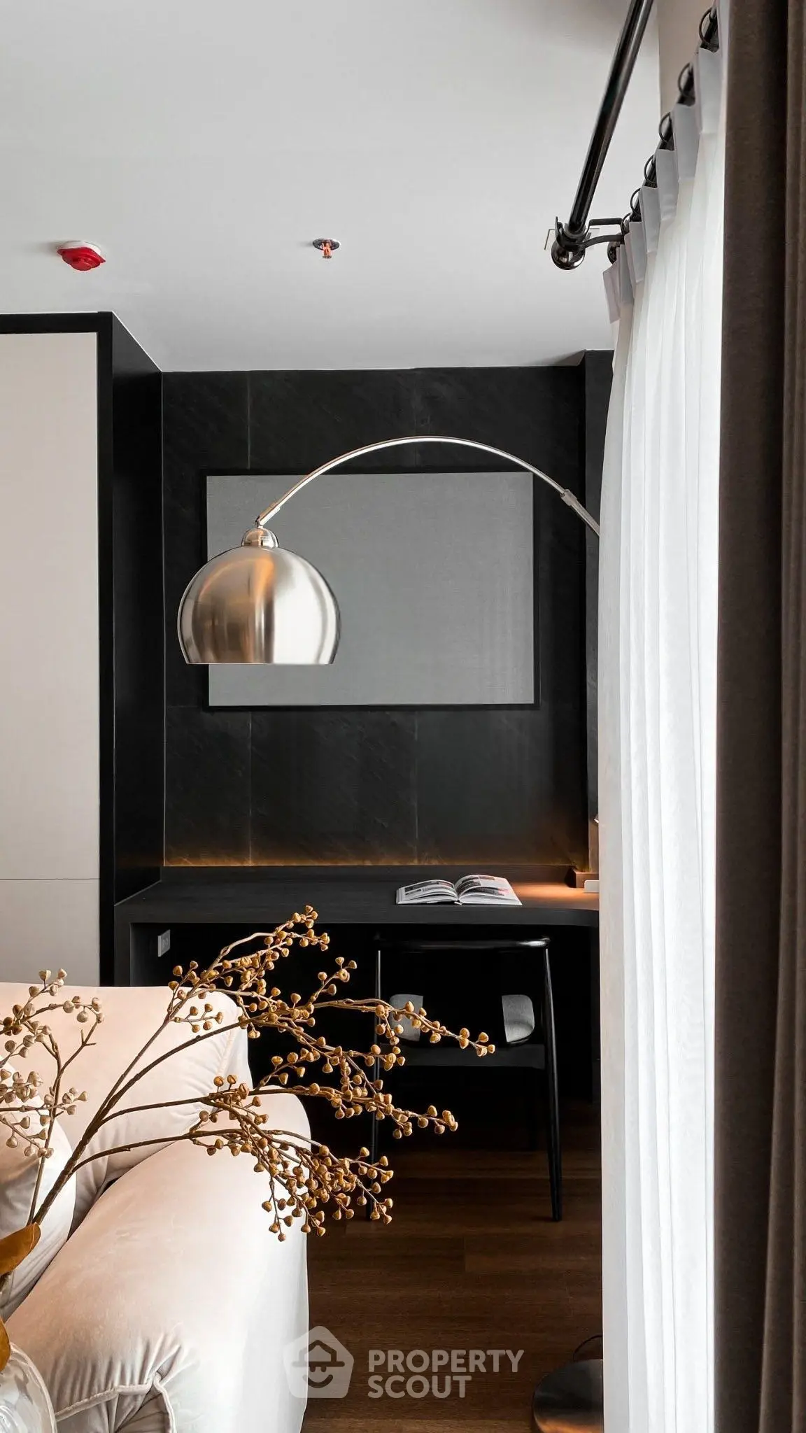 Modern living room with stylish decor and elegant lighting, featuring a cozy seating area and sleek design elements.
