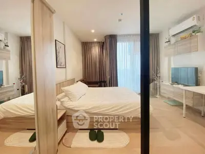 Modern bedroom with cozy decor and natural light, featuring a stylish bed and elegant furnishings.