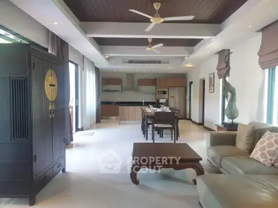 Spacious open-plan living room with modern kitchen and elegant decor