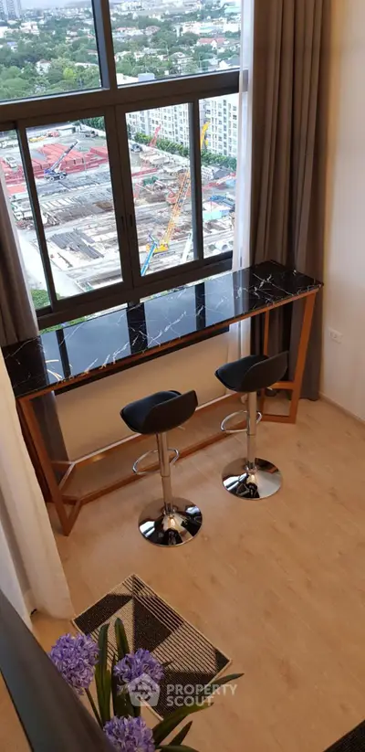 Stylish high-rise apartment with panoramic city view and modern bar seating area.