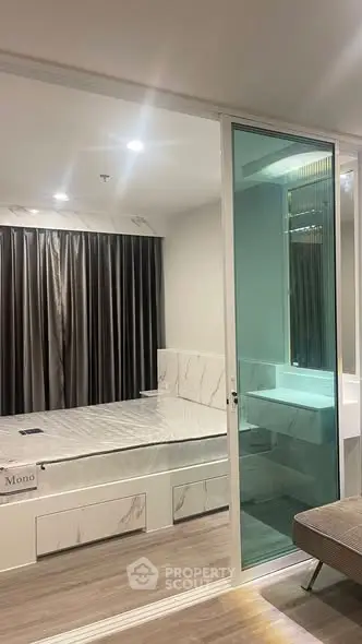 Modern bedroom with glass partition and stylish decor