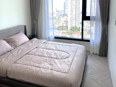 Modern bedroom with large window offering stunning city view