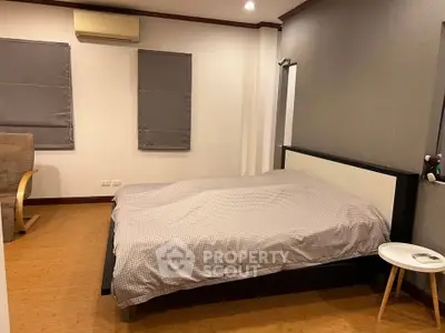 Spacious bedroom with modern decor and cozy ambiance
