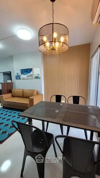 Modern dining area with stylish lighting and cozy seating in a contemporary apartment.