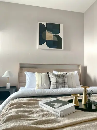 Stylish bedroom with modern decor and cozy bedding, perfect for relaxation.