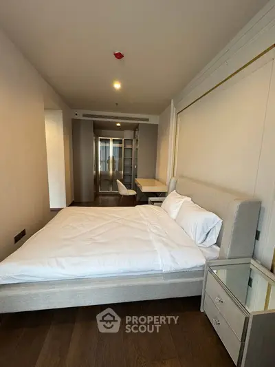 Modern bedroom with sleek design and cozy ambiance in a stylish apartment.