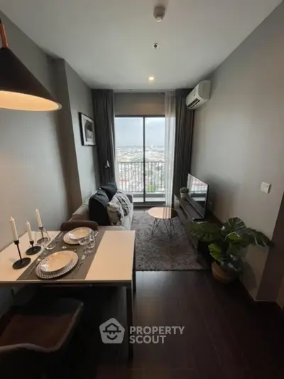 Modern living room with city view, stylish decor, and dining area in a high-rise apartment.