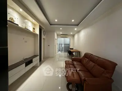 Spacious living room with modern furniture and sleek design, perfect for relaxation and entertainment.