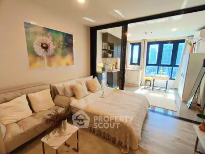 Modern studio apartment with cozy living area and city view