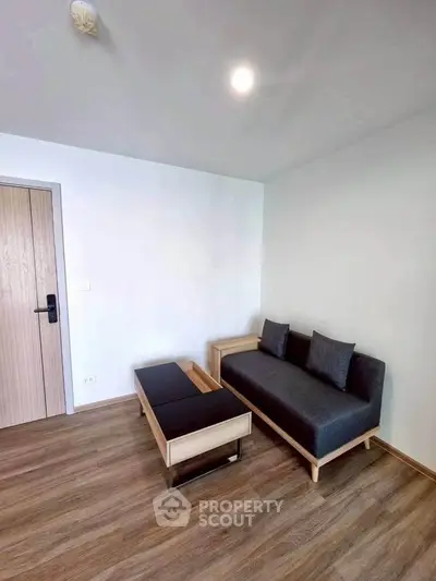 Modern minimalist living room with sleek furniture and wooden flooring