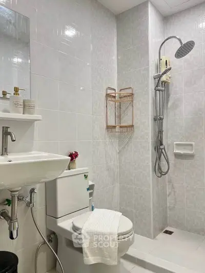 Modern bathroom with sleek shower and elegant fixtures in a contemporary home.