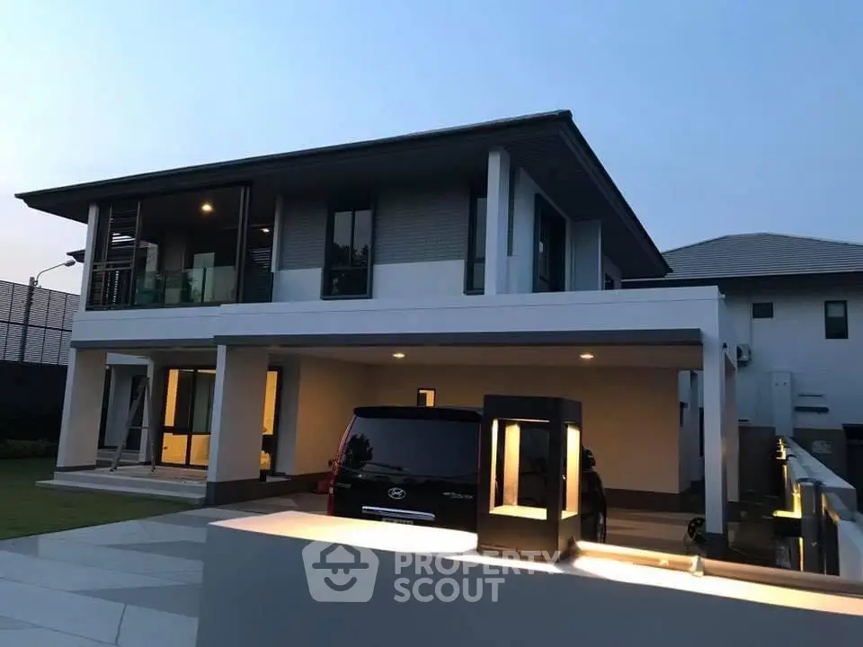 Modern two-story house with spacious driveway and sleek exterior lighting