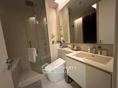 Modern bathroom with sleek fixtures and glass shower enclosure