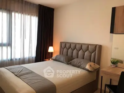 Cozy bedroom with modern decor and natural light in a stylish apartment.