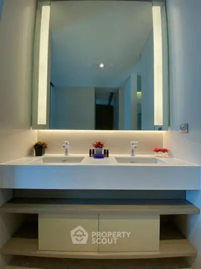 Modern bathroom with dual sinks and elegant lighting