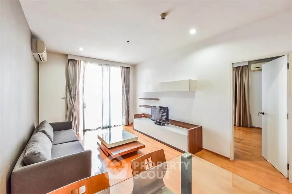 Modern living room with sleek furniture and natural light in a stylish apartment.
