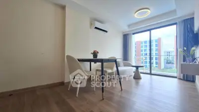 Modern living room with large windows and stylish furniture in a high-rise apartment.
