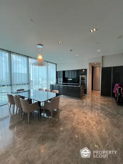 Luxurious open-plan kitchen and dining area with marble flooring and panoramic city views.