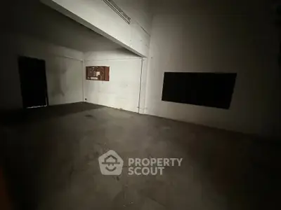 Spacious empty room with high ceilings and minimalistic design, ideal for customization.