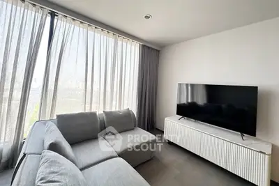Modern living room with large windows and sleek furniture