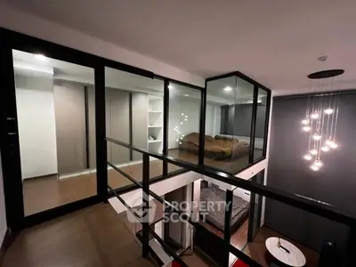 Modern loft with glass-walled bedroom and stylish lighting