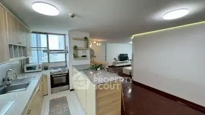 Spacious open-plan kitchen and living area with modern appliances and natural light.