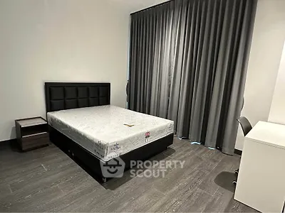 Modern minimalist bedroom with sleek design and ample natural light