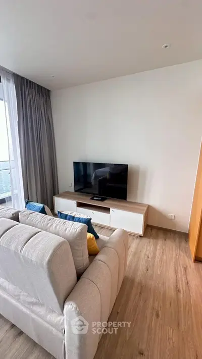 Modern living room with sleek TV setup and cozy seating area