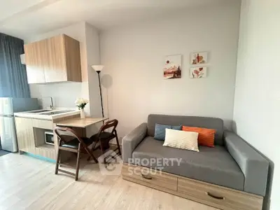 Modern studio apartment with cozy living area and compact kitchen