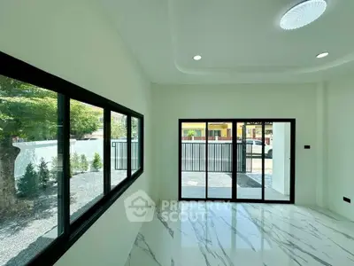 Spacious modern living room with large windows and marble flooring