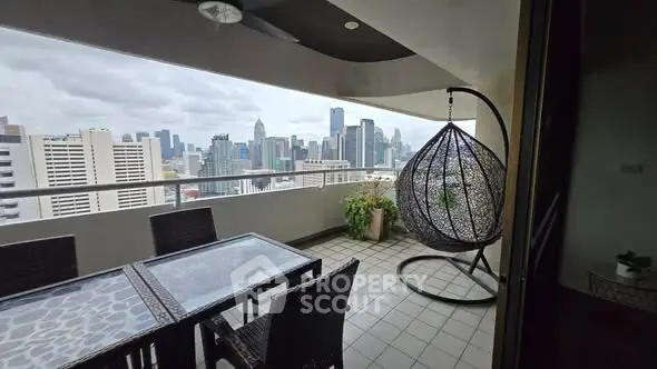 Spacious balcony with stunning city skyline view and modern outdoor furniture.