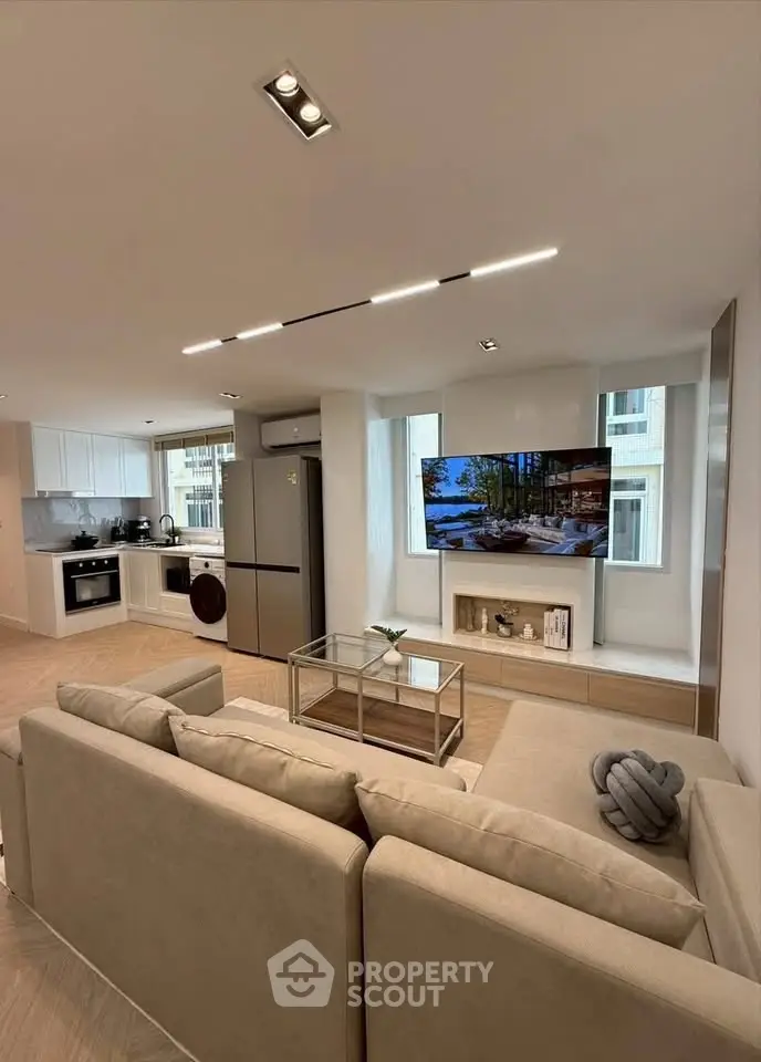Modern open-plan living room with sleek kitchen and stylish decor