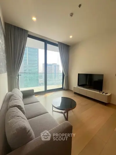 Modern living room with city view, featuring sleek furniture and floor-to-ceiling windows.