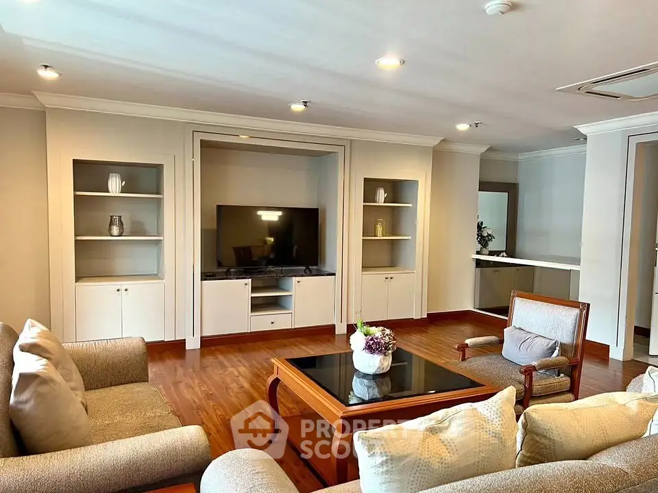 Spacious living room with elegant furniture and built-in entertainment center