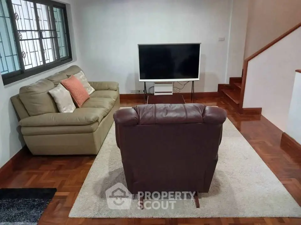 Cozy living room with modern TV setup and comfortable seating