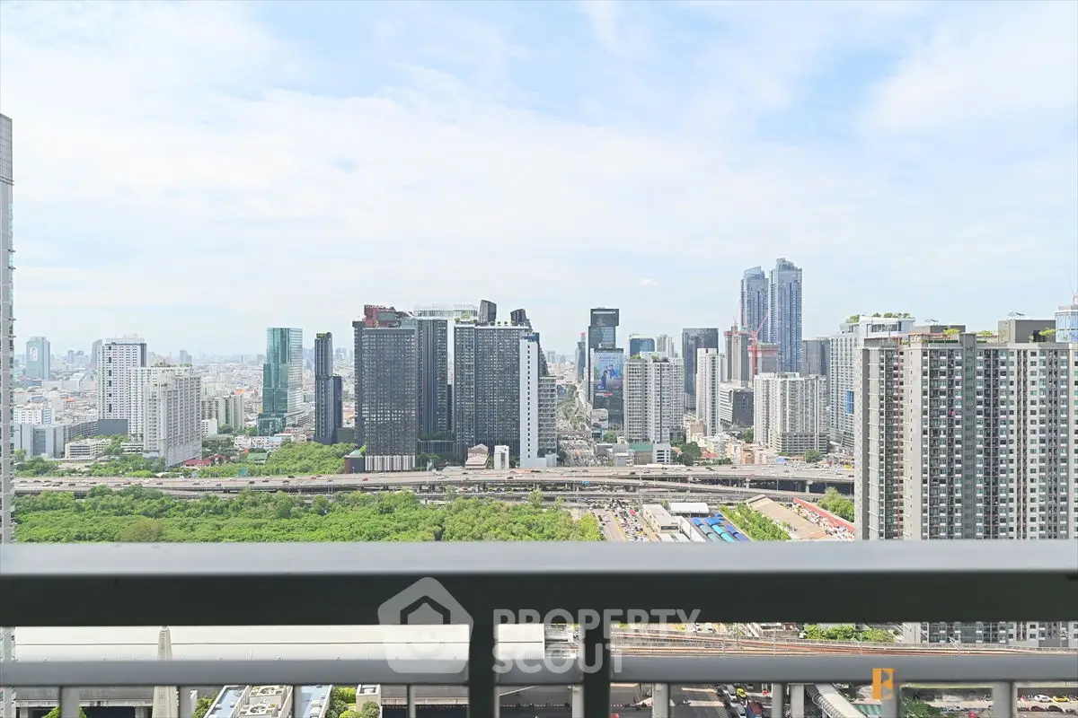 Stunning cityscape view from high-rise balcony overlooking urban skyline.