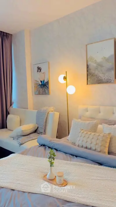 Elegant bedroom with modern decor, featuring cozy bed, stylish lighting, and artistic wall art for a serene ambiance.