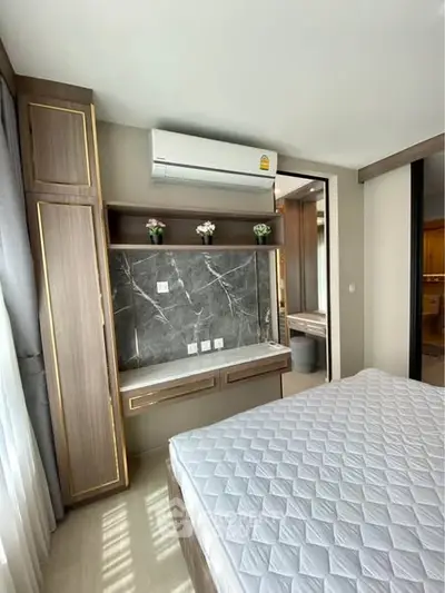 Modern bedroom with built-in storage and air conditioning unit