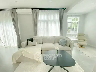 Bright and airy living room with modern furniture and large windows